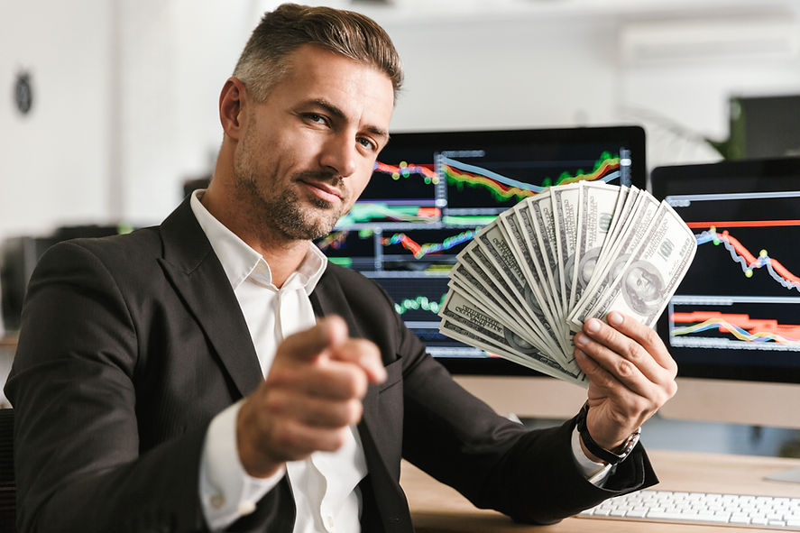 image-pleased-businessman-30s-wearing-suit-holding-money-fan-while-working-office-with-gra