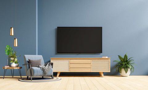 tv-cabinet-modern-living-room-with-armchair-dark-blue-concrete-wall-background.jpg