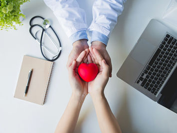 top-view-doctor-patient-hands-holding-red-heart-white-table.jpg