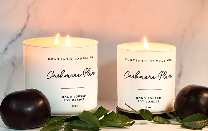 Two lit Contento Candles Co. hand-poured soy candles