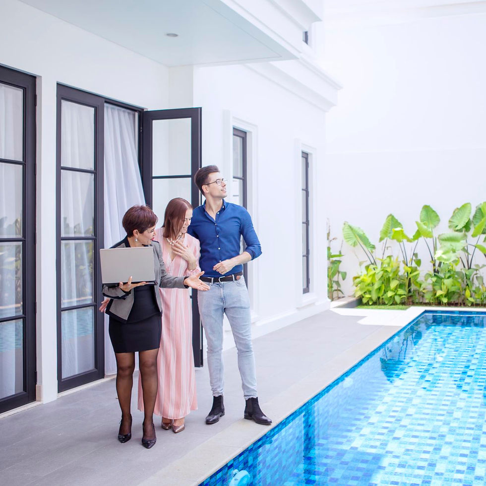 Couple touring a villa with a private pool alongside a real estate agent during a relocation retreat in Costa Rica