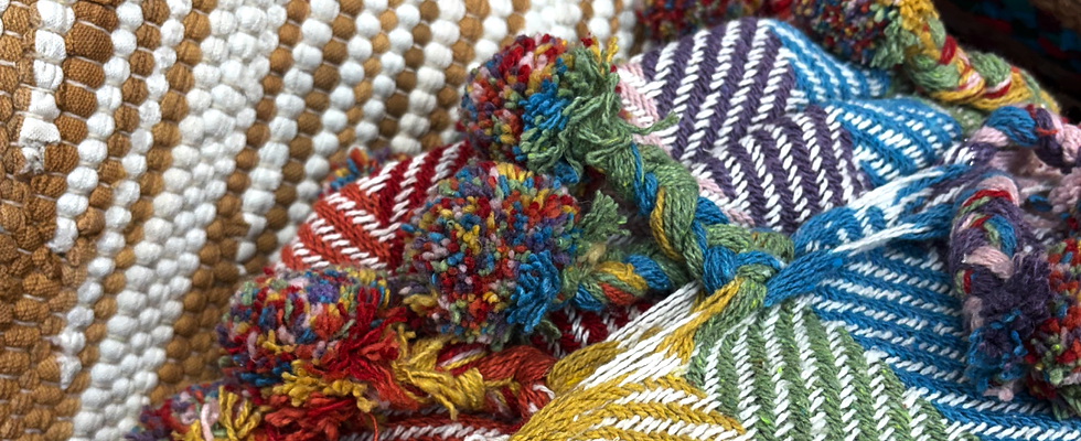 A picture of some blankets that are rainbow-coloured.