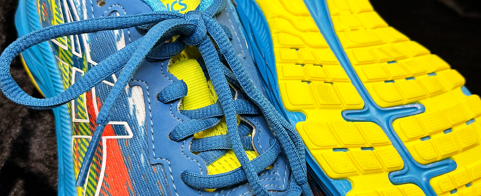 Turquoise ASICS trainers with yellow soles.