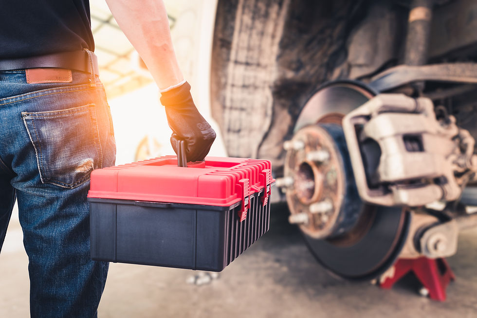 The abstract image of the back of technician hold a toolbox and blurred disc brake is back