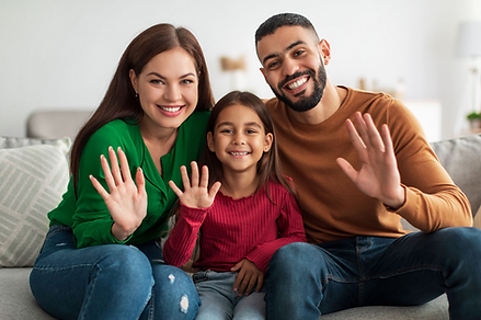 portrait-of-happy-family-waving-hands-at