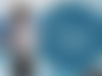 African American woman standing in front of ocean waves next to logo the healing spot