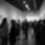 dynamic shot diverse creatives networking exhibition space warm lighting vibrant colors co