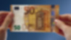 Person holding a €50 note in both hands