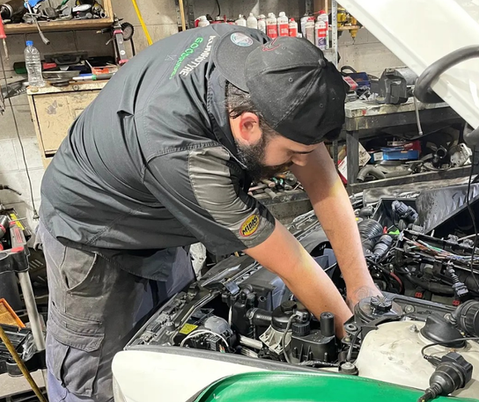 Secondary school student working on a car engine during Puatala automotive work experience programme