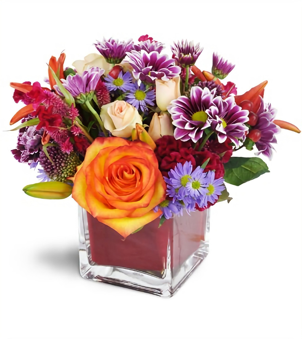 Spring Vase Arrangement - From $50-$150 Spring flowers arranged in a short glass vase.