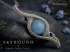 Skybound beginner wire wrapped pendant tutorial featuring a round light blue gemstone secured in an elegant silver wire frame with intricate woven details and deep blue accent stones. The handcrafted pendant hangs from a chain against a soft sky-inspired background with delicate dried flowers and crystal accents, creating a light, airy, and luxurious presentation.