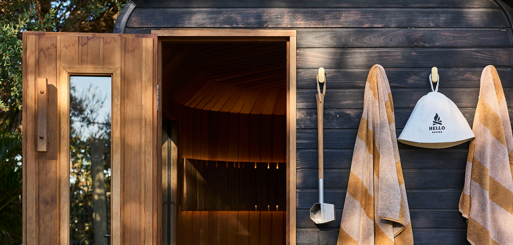 Wood-fired Hello Sauna with towels beside the open door