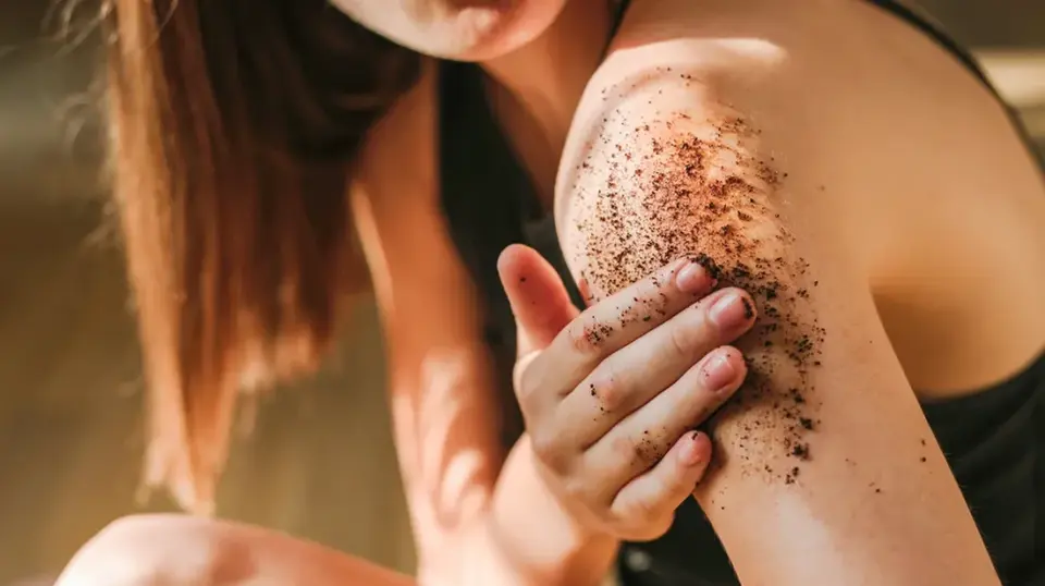 Woman using Coffee Body Scrub for exfoliation