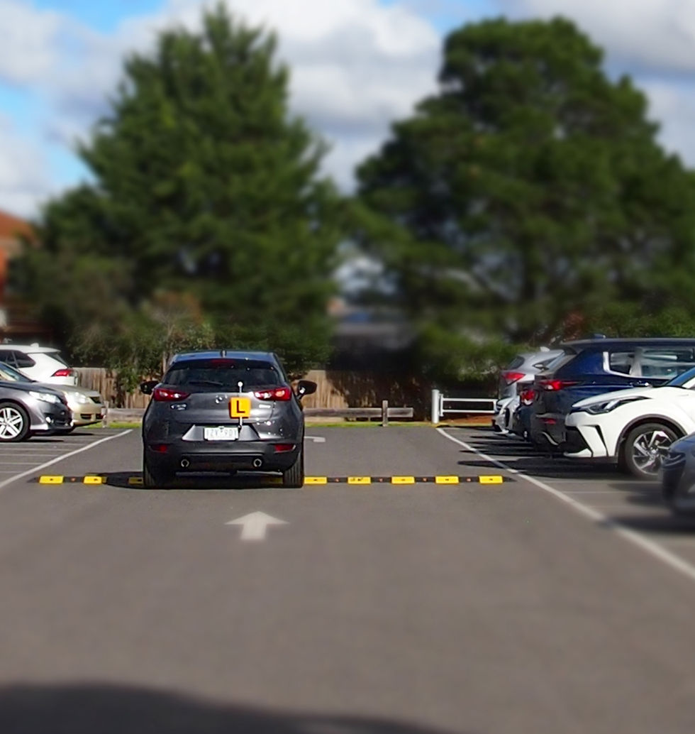 A car with an "L" plate practicing in a car park