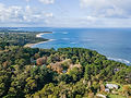 Aerial view of the mornington forested coastline with a sandy beach and blue ocean
