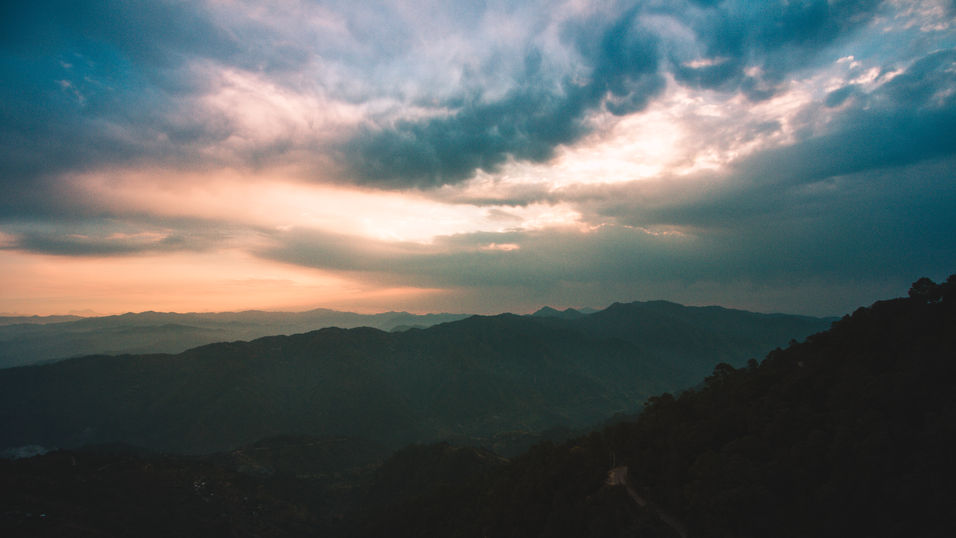 Lansdowne mountain sunset with dramatic cloudy sky and moody light over Uttarakhand hills