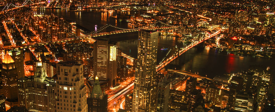 Aerial night view of Lower Manhattan with Brooklyn Bridge, Manhattan Bridge, and East River city lights