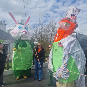 Two large puppets of a Bunny and a Leprauchan with their operators waiting to start the parade.