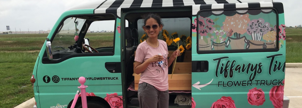 Girl with standing by flower truck