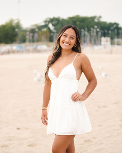 Young woman in white dress at the beach