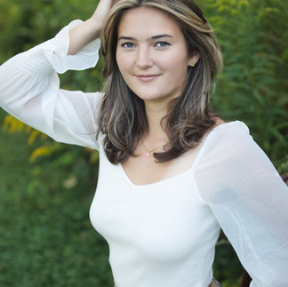 Girl with white shirt with hands on head