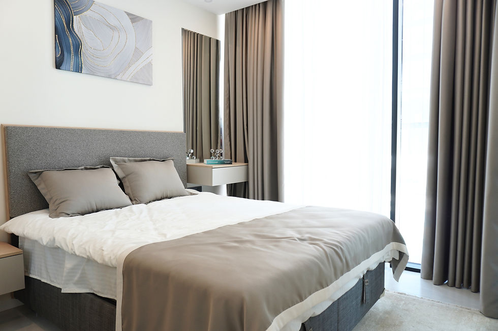 Furnished apartment bedroom with double bed and natural light