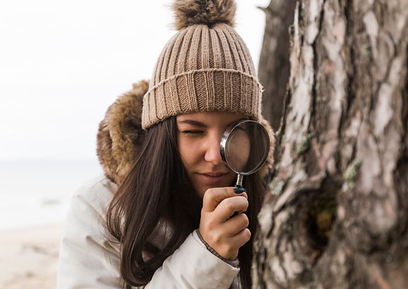 woman-looking-tree-bark-through-magnifying-glass.jpg