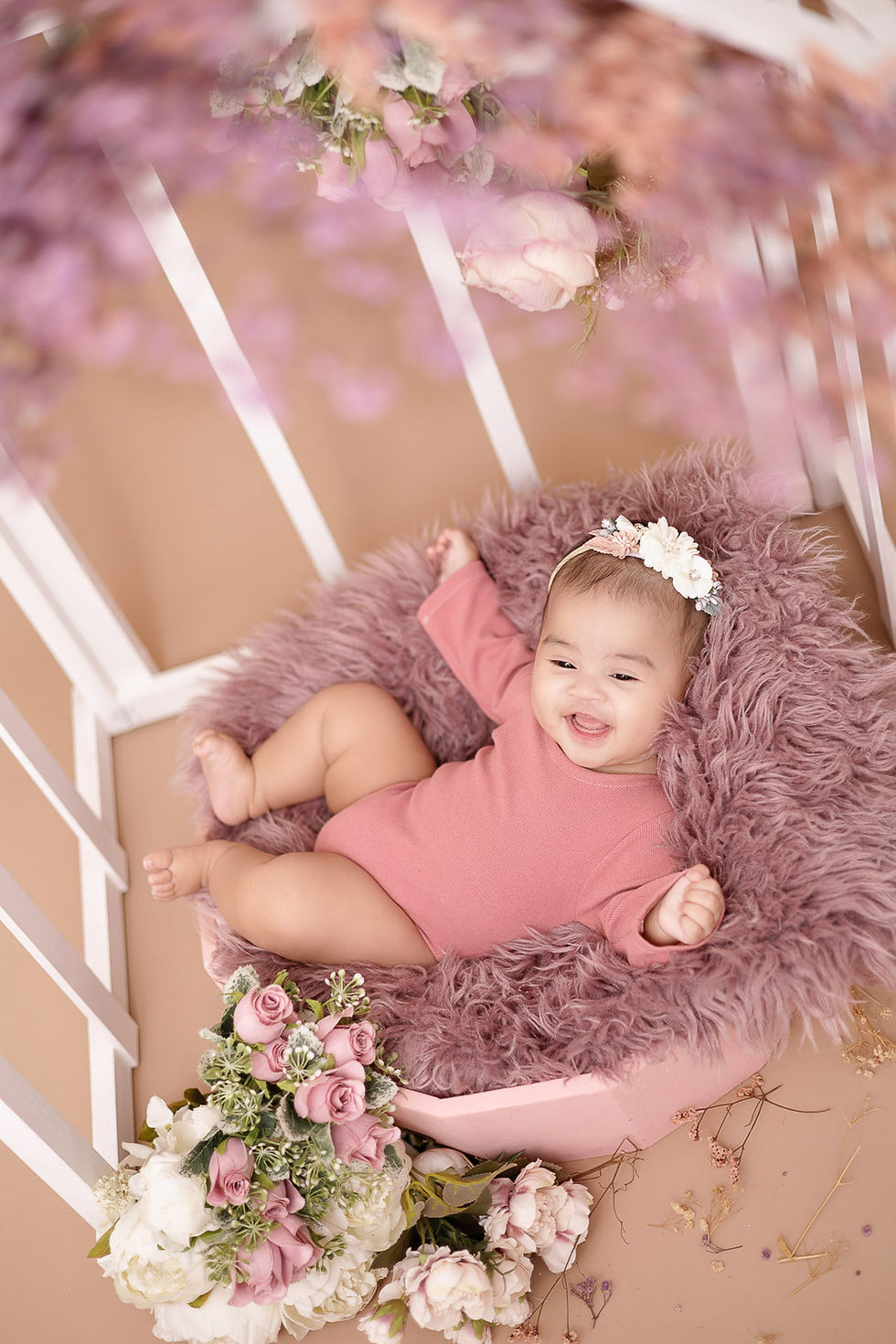3 months old baby girl smiling wearing pink romper
