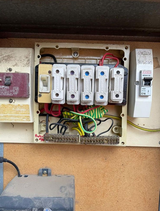 A close-up of a new, modern electrical switchboard with multiple circuit breakers.