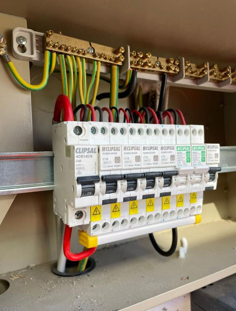 An open electrical panel showing complex wiring and connections.