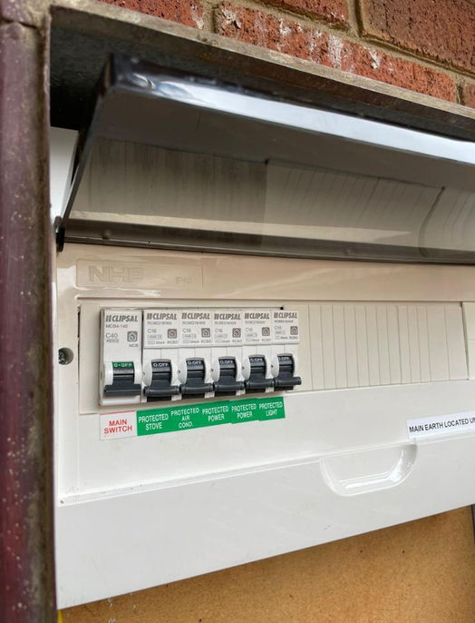 A new white switchboard installed on a brick wall.