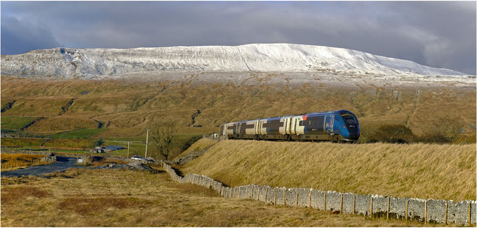 Whernside hill in yorkshire dales at Ribblehead with a class 805 unit at Ribblehead picture taken by creative authentic railway photographer eddie holden