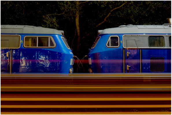 A long exposure shot at niebull whilst a car train passes a static pair of 218s.