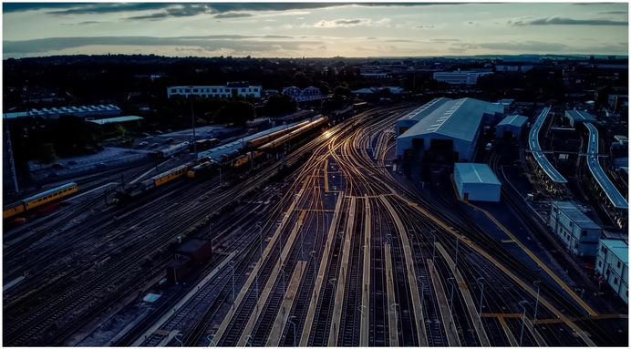 A picture taken by eddie holden who is a creative railway photographer. This shot shows track glinting in the sunlight as the sun sets over Derby.