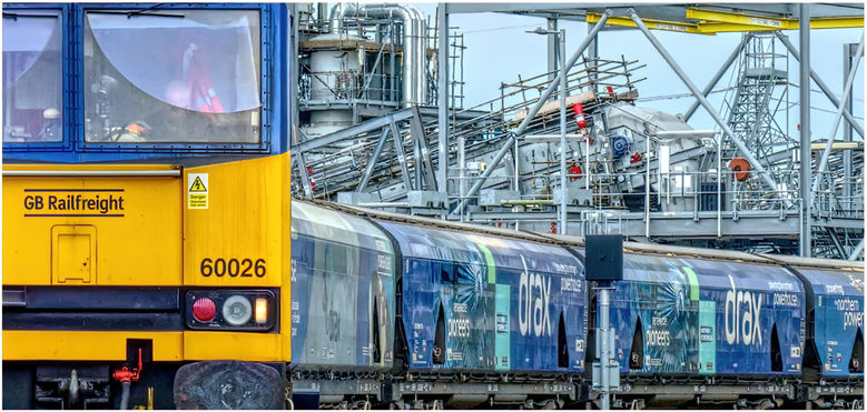 Drax Power station with a class 60 waiting to depart with a train of empty bio mass wagons.