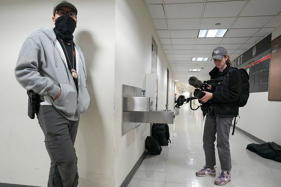 Documentary filmmaker Emma V.F. films a masked ICE agent in immigration court using a Canon C500 camera.