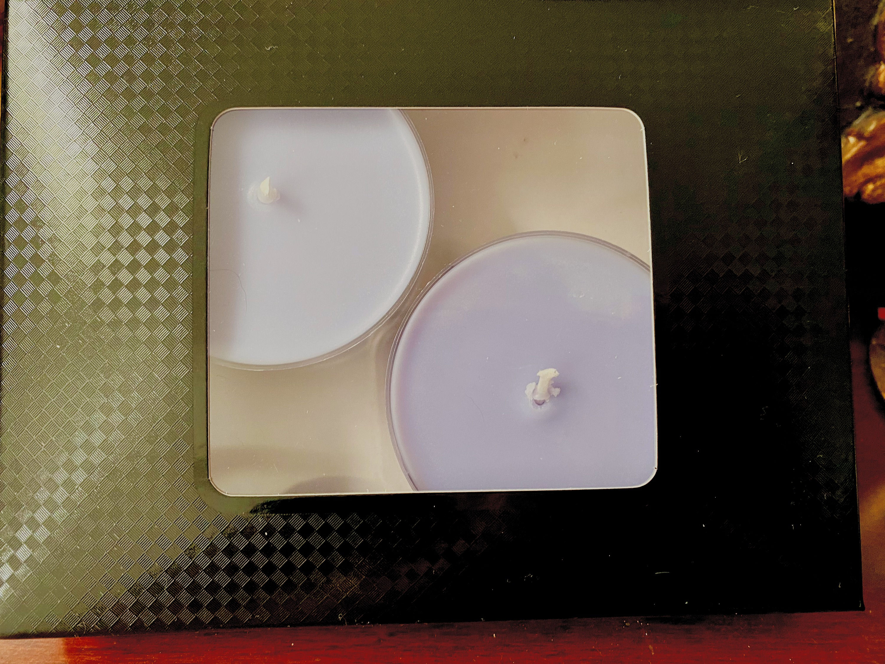 White large tea light candles in a black box
