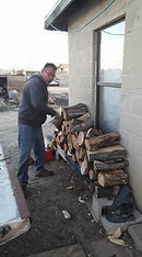 Hopi community member with wood they received from HERF services