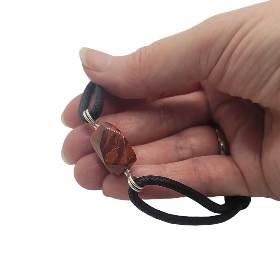 Thumbnail: Mens cord bracelet with large red jasper bead, displayed in hand