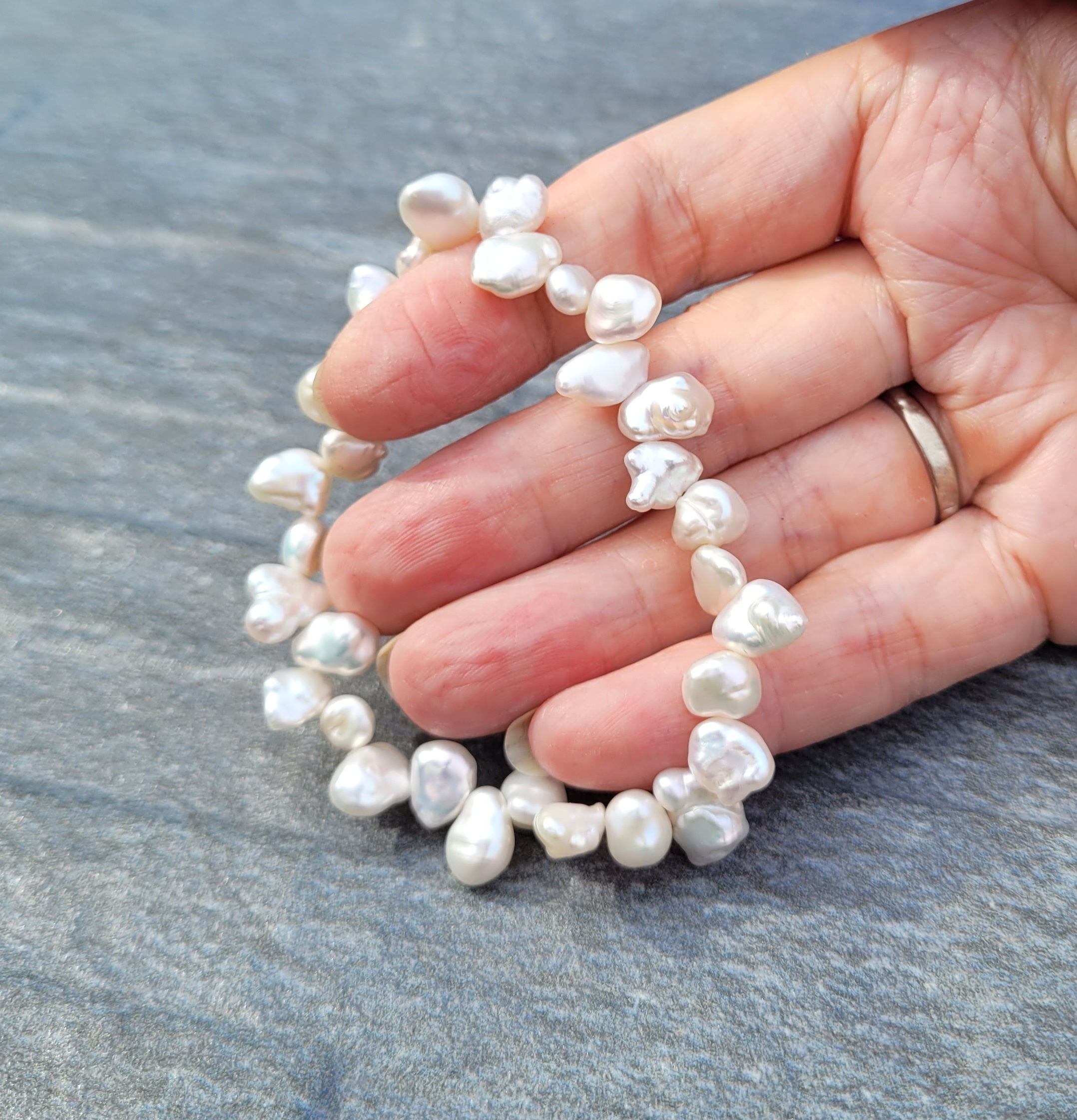 Keshi cultured pearl bracelet displayed in hand