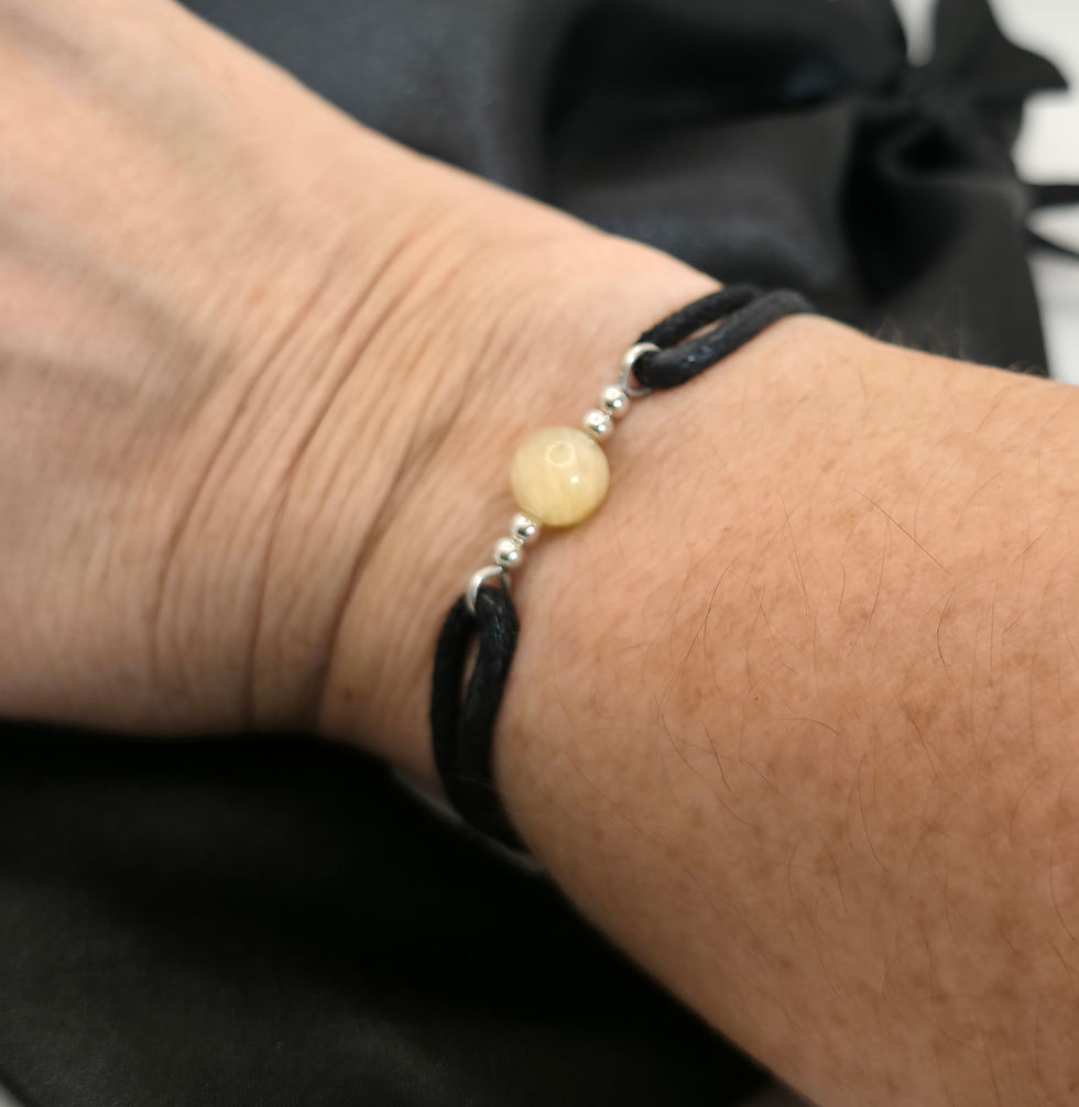 Thumbnail: Black cord bracelet with yellow selenite bead displayed on wrist