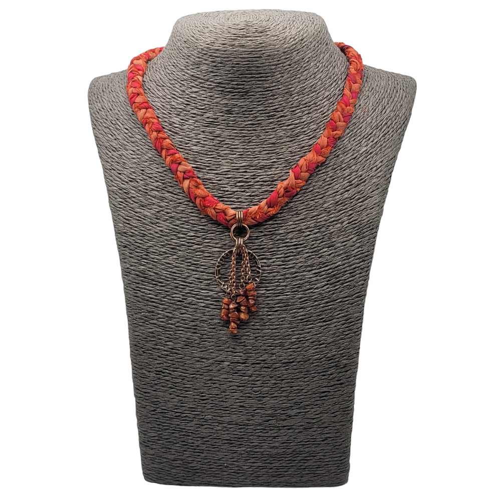 Thumbnail: Burnt orange plaited sari silk choker with fire opal beads at the front. Displayed on a grey necklace bust.