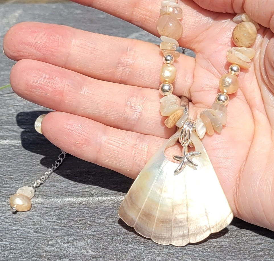 Thumbnail: Moonstone, Mother of Pearl and Shell necklace displayed on hand