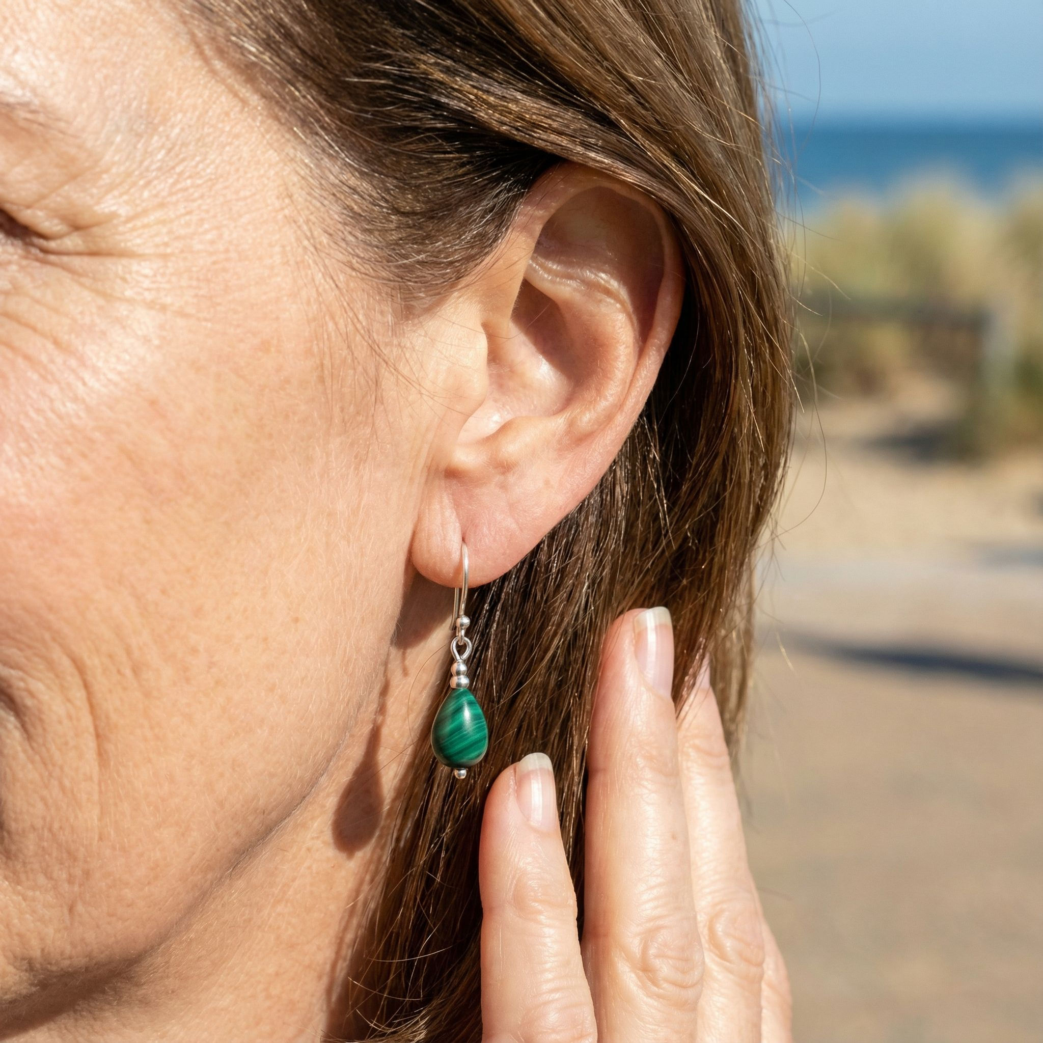 Model wearing Malachite and sterling silver earrings