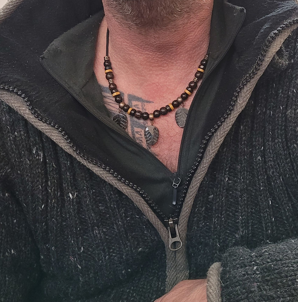 Beaded necklace on cord with 3 Arfvedsonite charms, displayed on male model