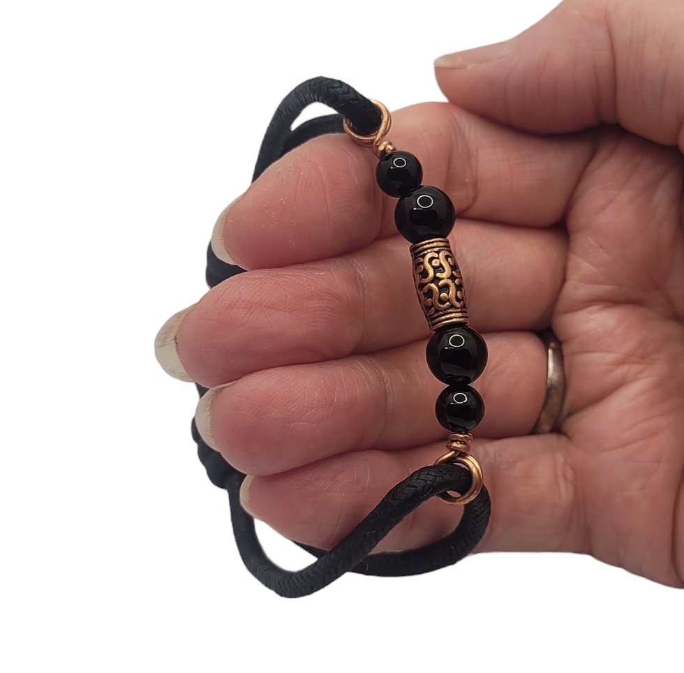 Thumbnail: Mens cord bracelet with black onyx and copper beads, displayed on hand