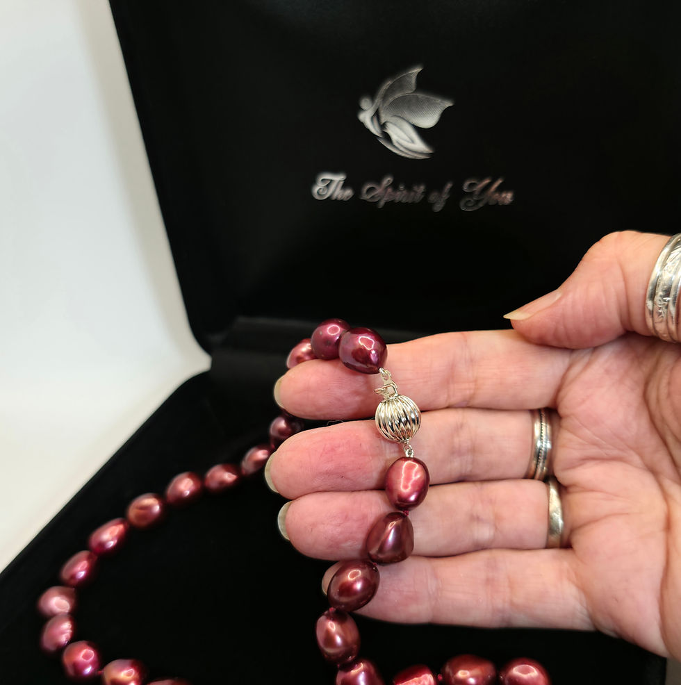 Thumbnail: Hand holding Red freshwater cultured pearls with sterling silver clasp