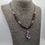 Thumbnail: Wooden beaded amethyst necklace with large amethyst pendant on cord, displayed on grey necklace bust