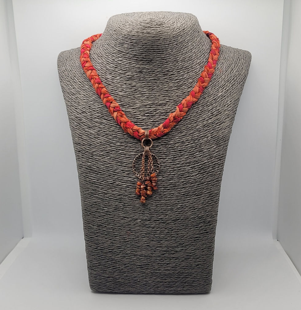Thumbnail: Burnt orange plaited sari silk choker with fire opal beads at the front. Displayed on a grey necklace bust.