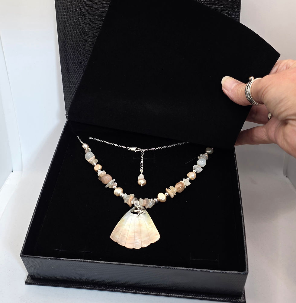 Thumbnail: Moonstone, Mother of Pearl and Shell necklace displayed in black jewellery box